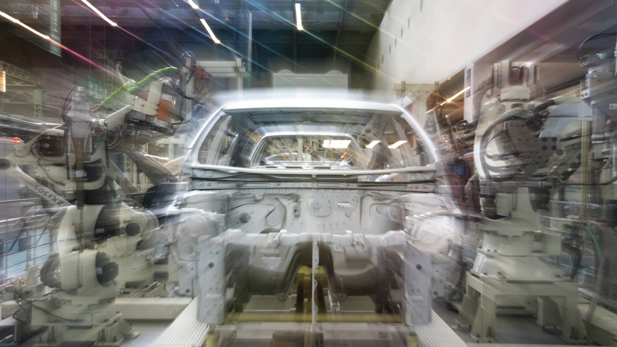 Robotic arms assembling a car body on an automotive production line