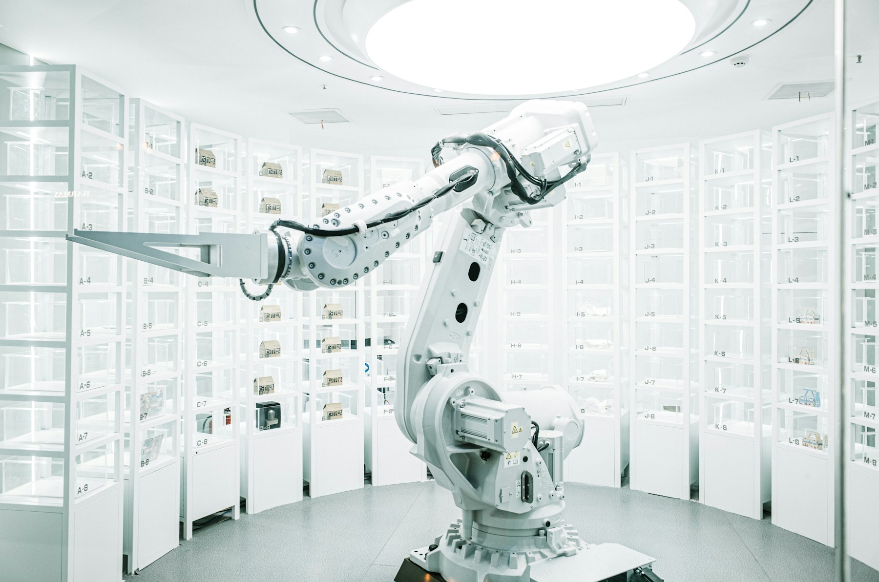 White robotic arm on a stand in a clean showroom
