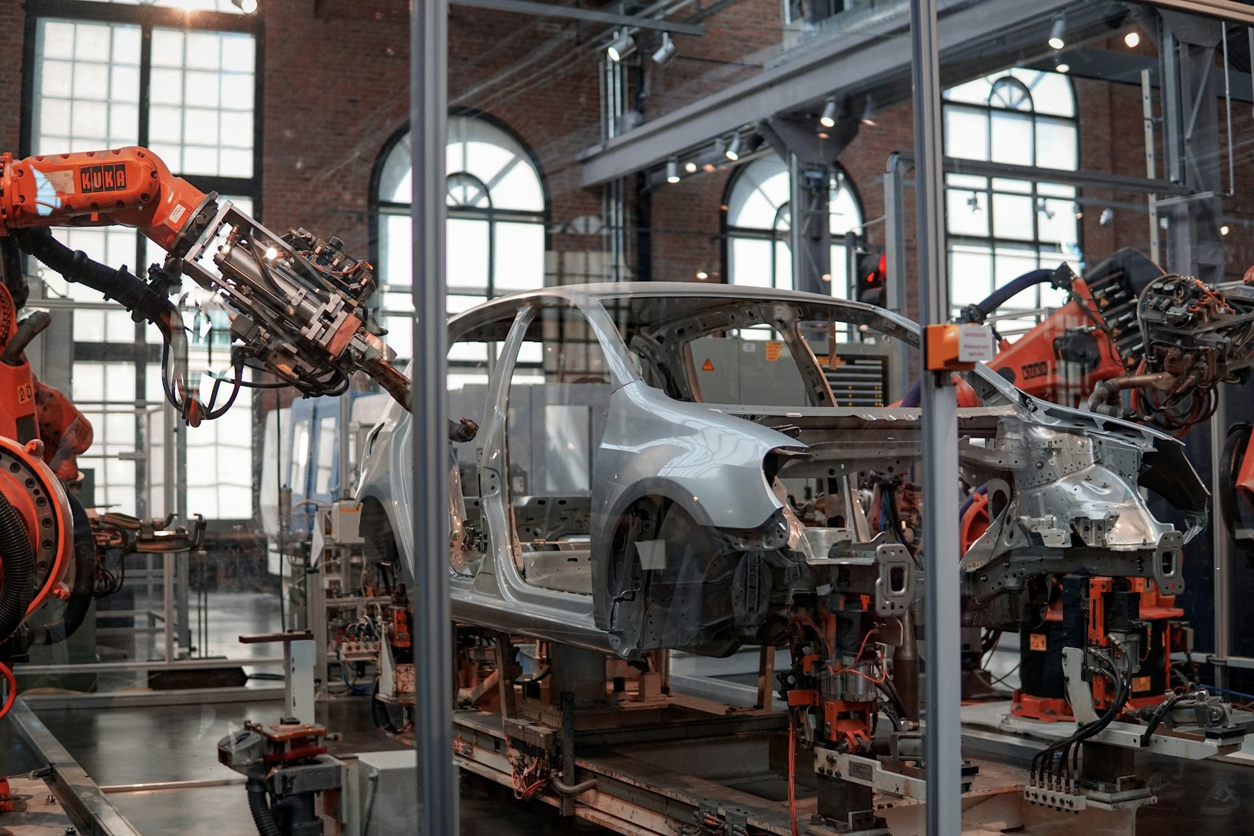 Robotic arms assembling a car body on an automotive production line