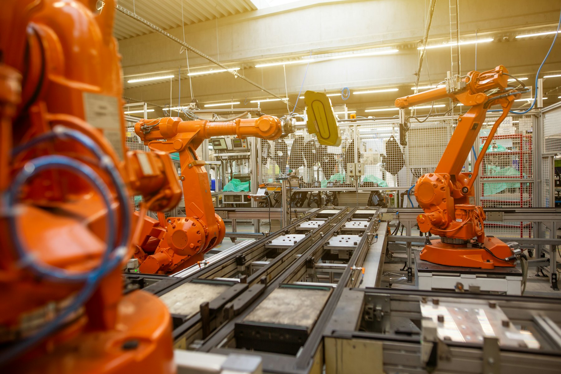 Factory hall filled with orange industrial machines