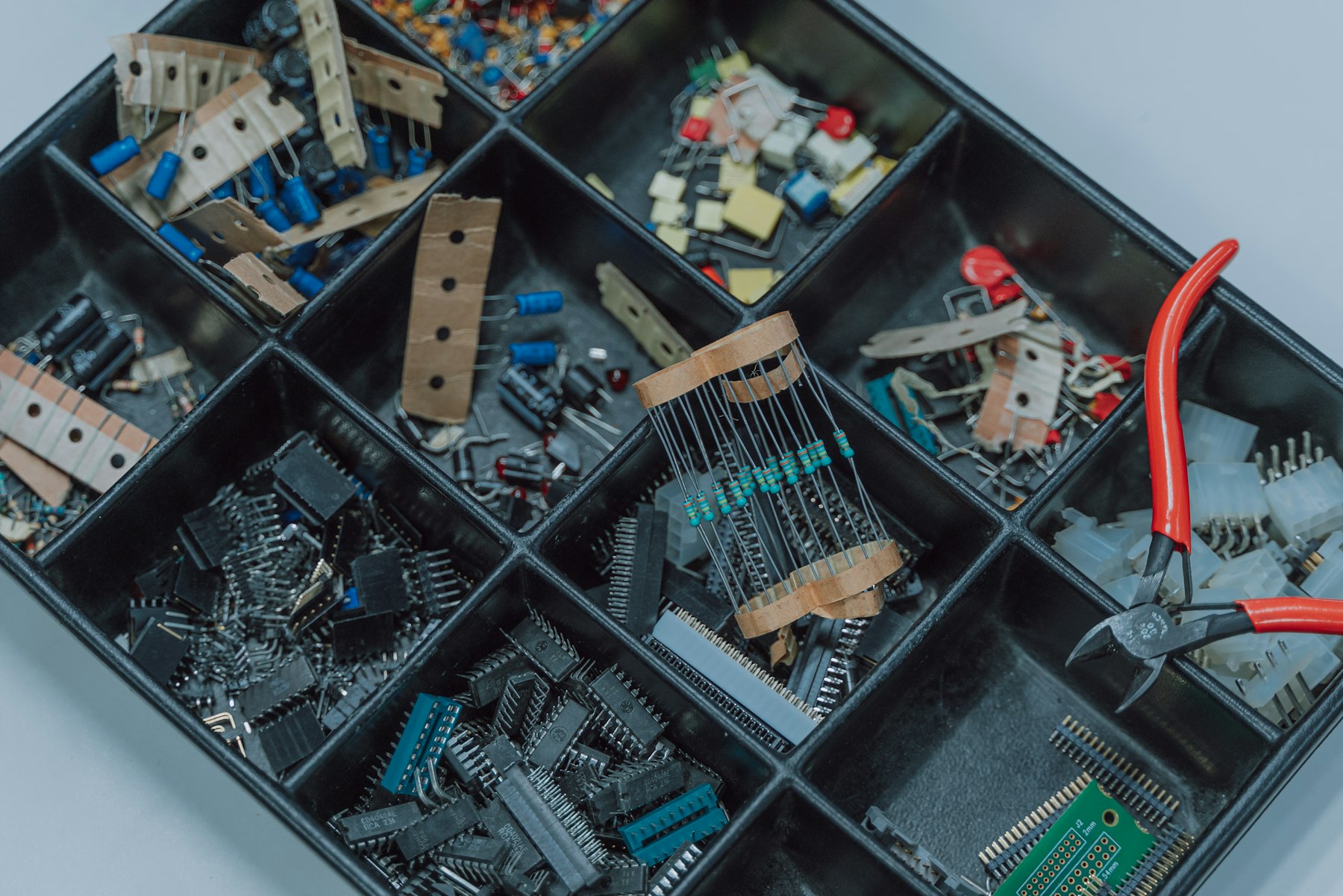 Sorted trays of electronic components, one compartment empty